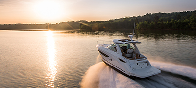 A Sea Ray Sundancer 350 cruising towards the sunset