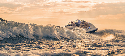 Large wake behind a running boat at sunset