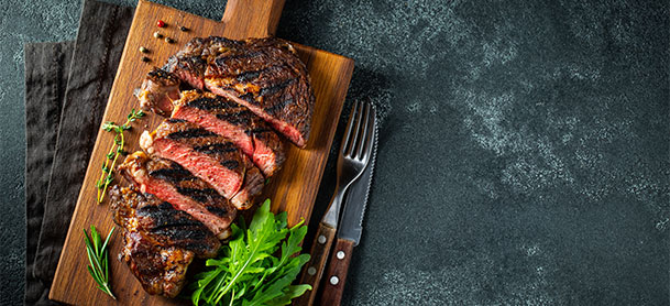 Cut steak on a board