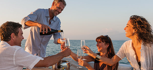 group enjoying champagne on the deck of a yacht