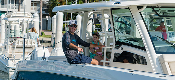 man sitting on the edge of a fishing boat