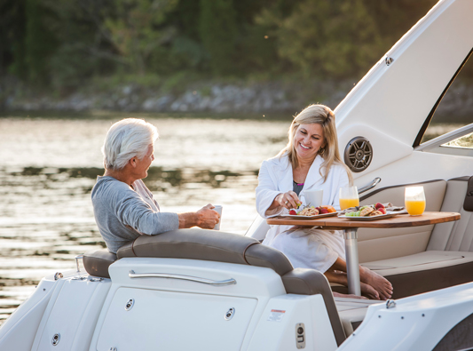 Couple enjoys breakfast on boat