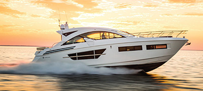 A Cruisers Yacht sails at sunset