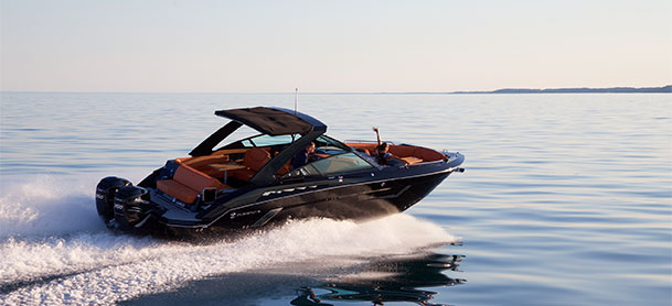Cruisers Yacht black boat driving on water