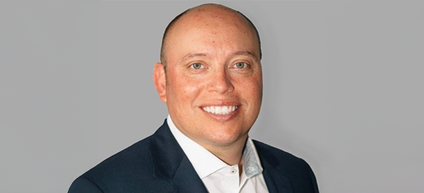 Dale Hardison, smiling in a suit and tie, is introduced as the new General Manager of MarineMax Wrightsville Beach.