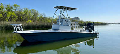 A blue and white Dargel boat idles on the water