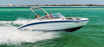 A dual console boat with two boaters on the water