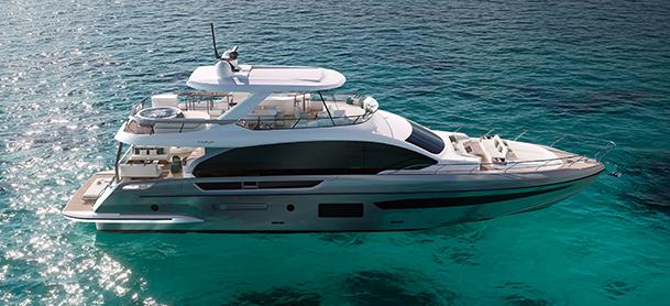 Azimut Grande 25M on clear blue water, viewed from the side.