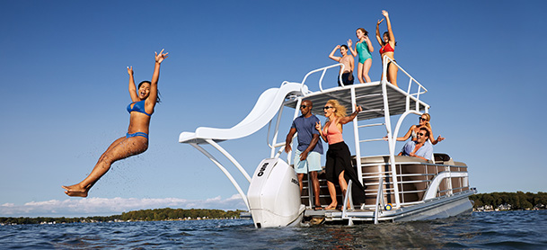 people on pontoon boat with slide