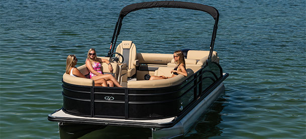 Group of woman lounging on the back of a Harris Pontoon