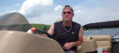 Man driving pontoon