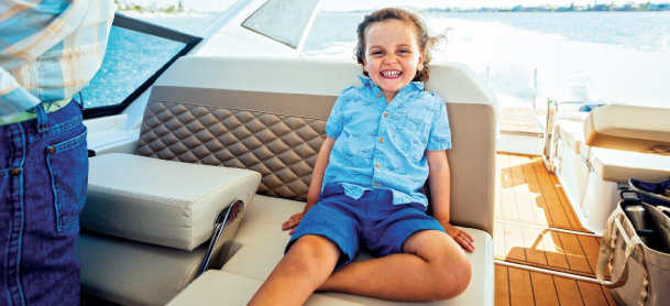 Kid enjoying his day on a boat