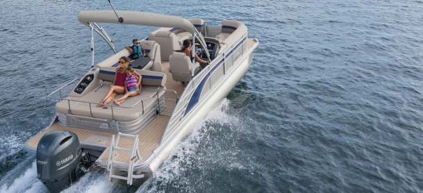 Pontoon boat running safely on the water with a family on board