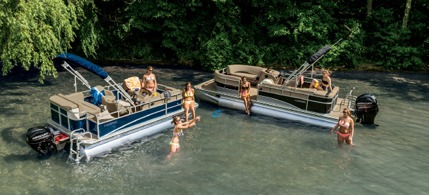Pontoon boats with people out on a sandbar
