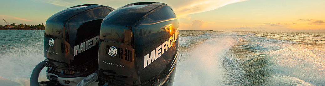 Mercury outboard engines with the sunset behind them
