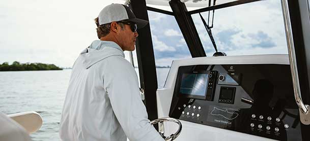 Man at the helm of a Aquila 47 Molokai