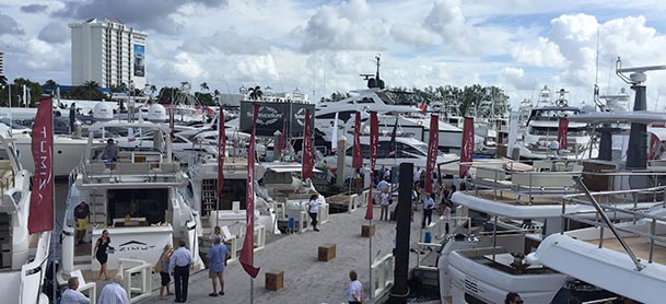 people walking along the dock at an outdoor boat show