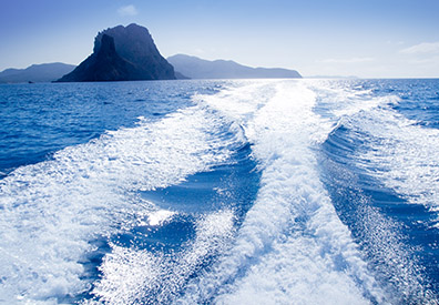 wake in water with island in distance