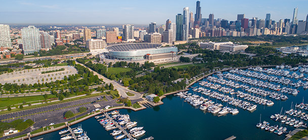 An aerial view of Chicago, with numerous boats docked near the coastline