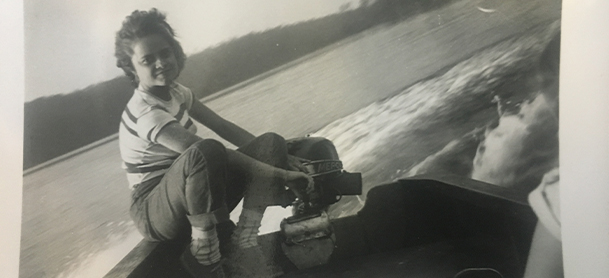 A woman aboard a Boston Whaler boat in black and white