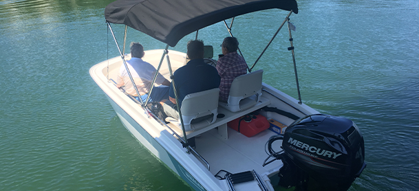 People aboard a Boston Whaler boat in the water