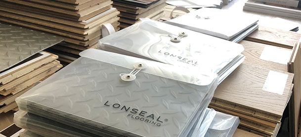 A pile of materials used for a boat, including wood, upholstery, and flooring.