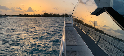 Sunset reflecting off an Azimut yacht on the water