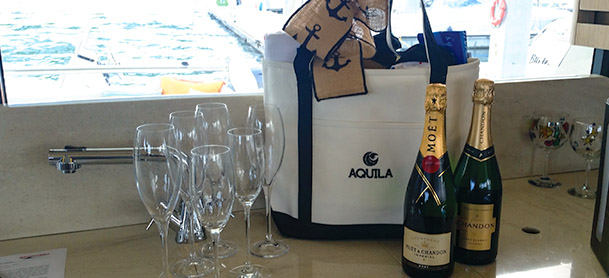 champagne, glassware, and a beach bag sitting on a countertop