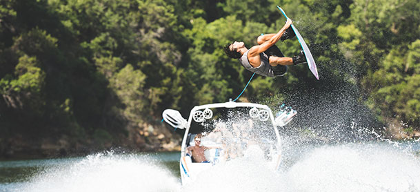 A Tige boat in the water with a wakesurfer