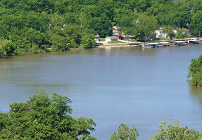 curving lake with lush green trees on the shore