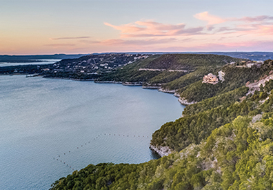 grassy hill dropping dramatically into the lake