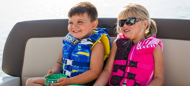 Two kids aboard a boat