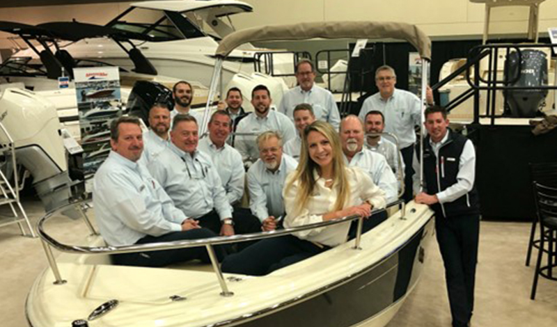 A group of MarineMax employees in a boat