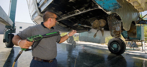 Technicnan pressure washing bottom of boat