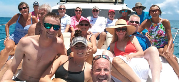 Group of people smiling on a boat