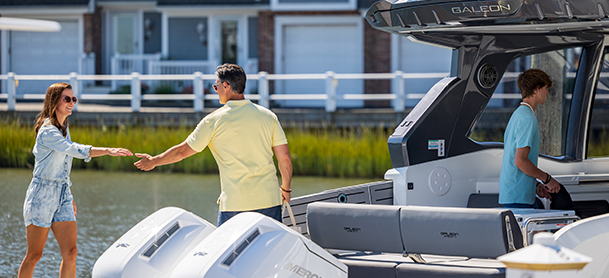 A couple joining hands as they prepare to board a boat.