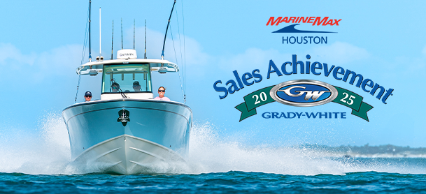 A large boat cuts through ocean waves under a clear blue sky. The text reads "MarineMax Houston Sales Achievement 2025 Grady-White," conveying success and celebration.