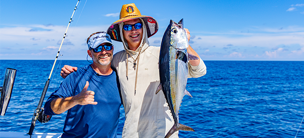 two fishers displaying their catch