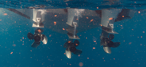 Outboard engine blades churning through the water