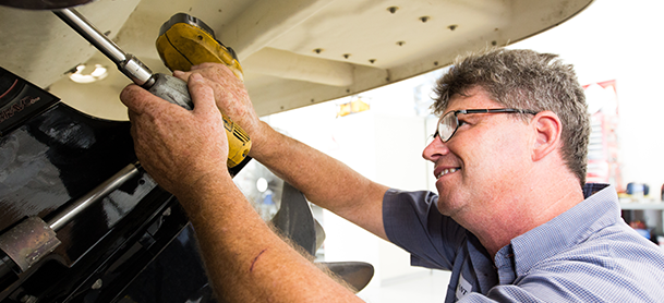A boat technician performing routine maintenance