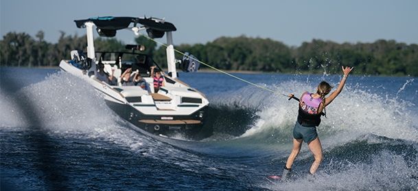 man surfing behind a boat
