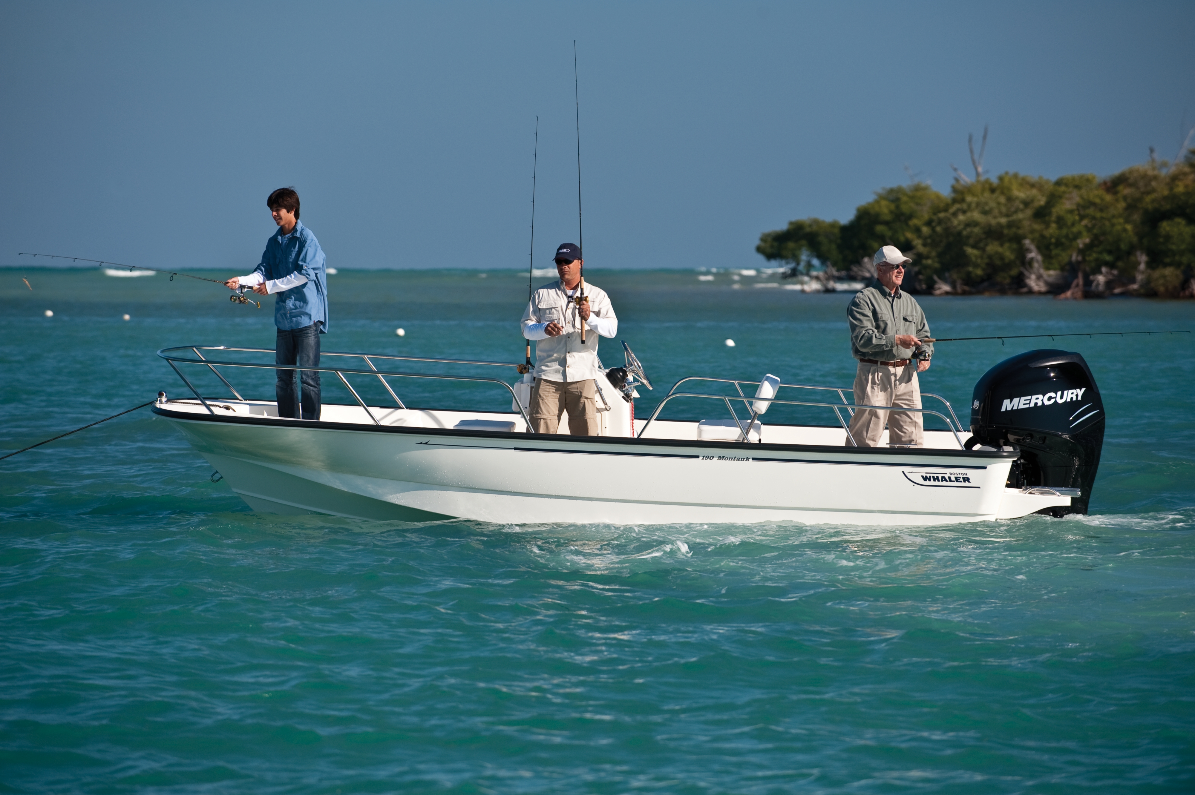 Group casting their fishing poles while on freshwater boat
