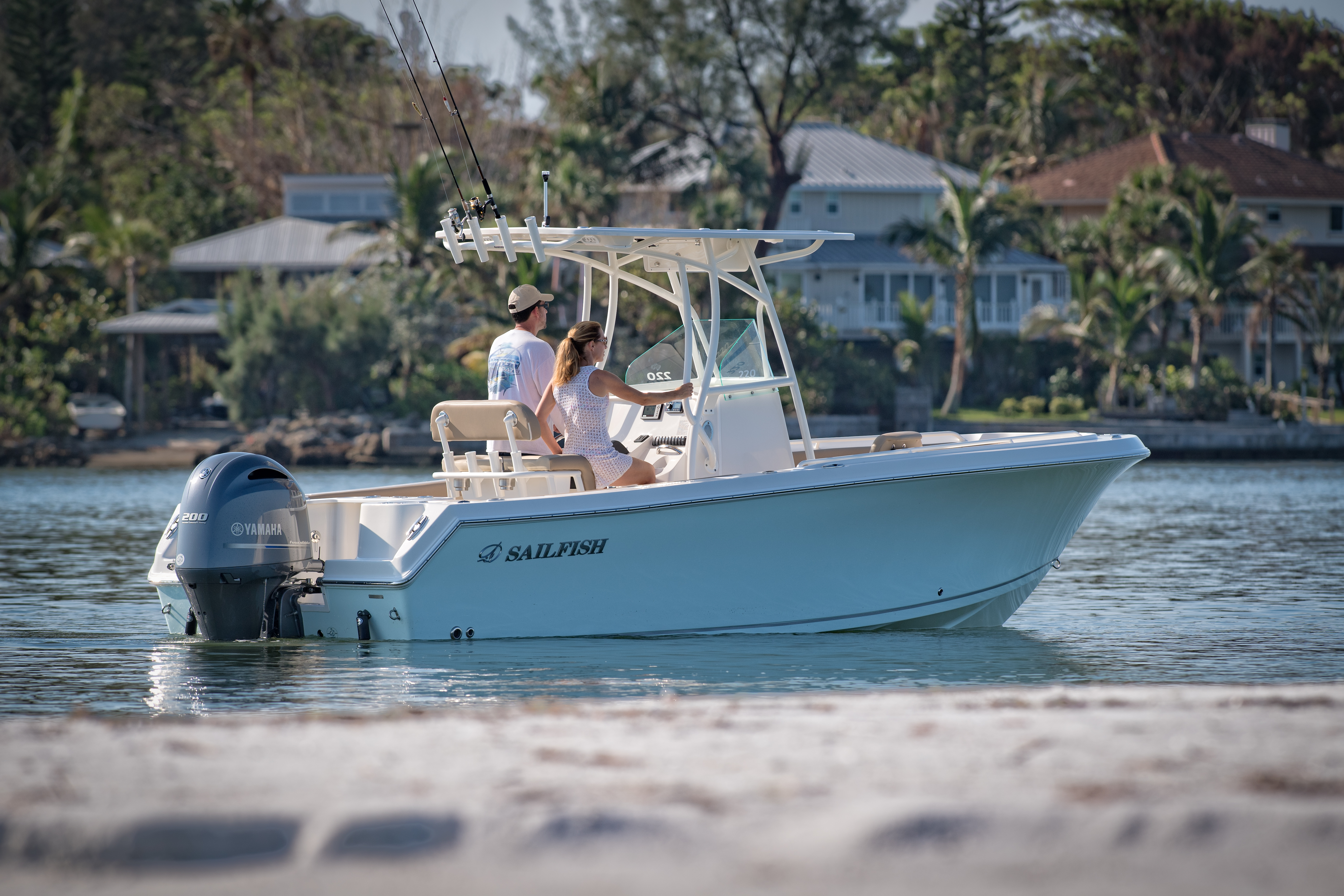 Couple slowly cruising in the water on a center console boat