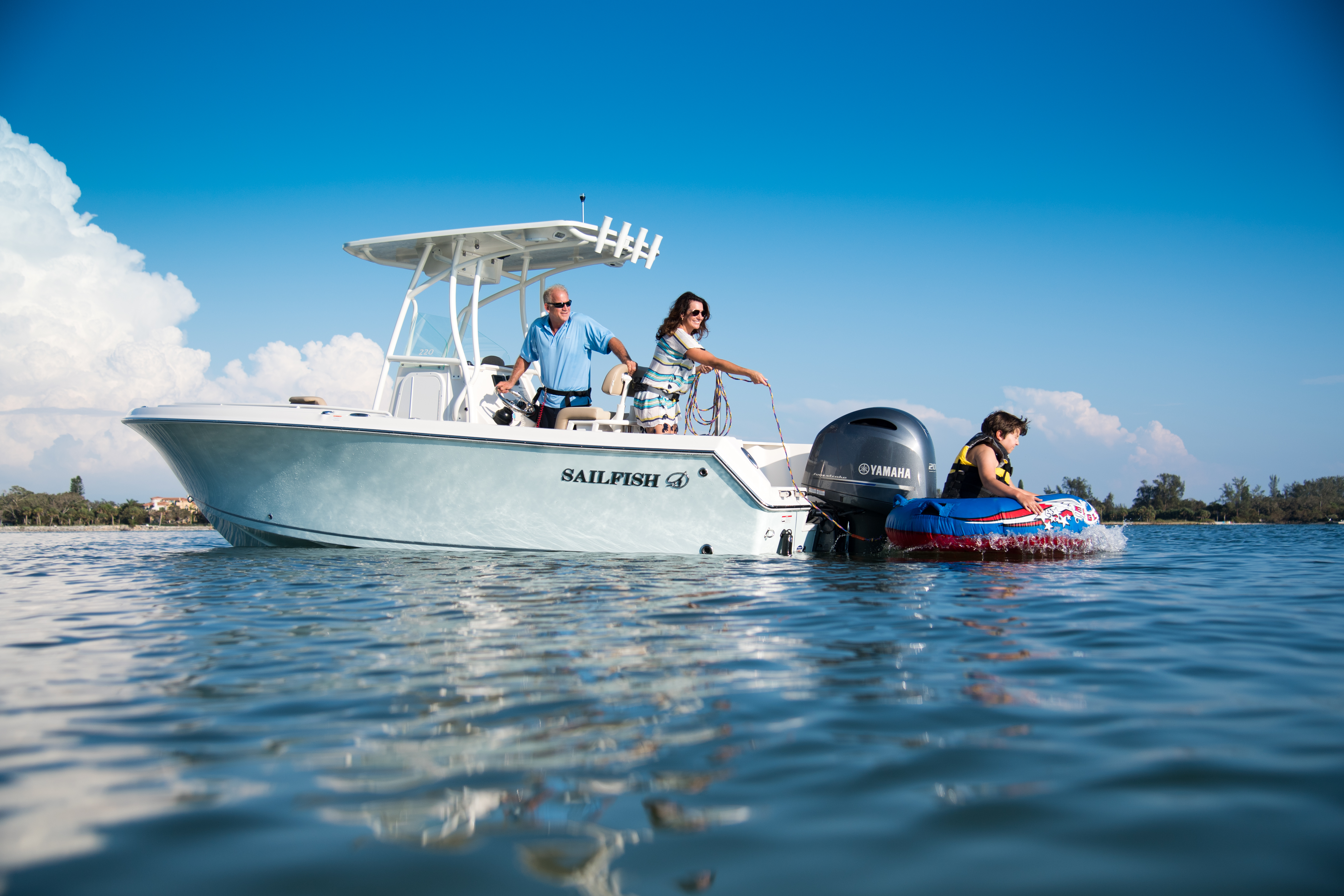 Center console boat out on water with family
