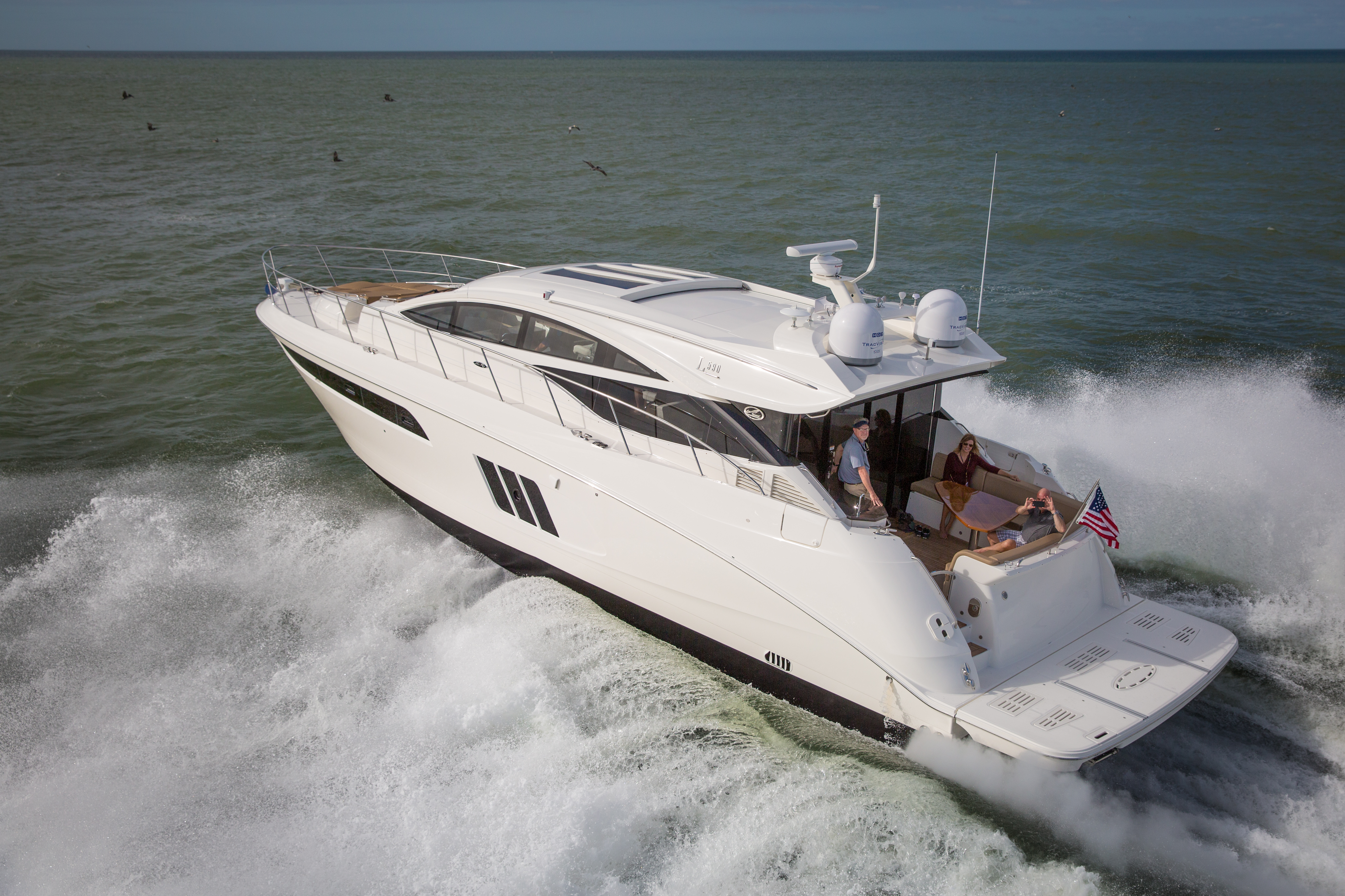 A cruising motor yacht out on the water traveling to the destination