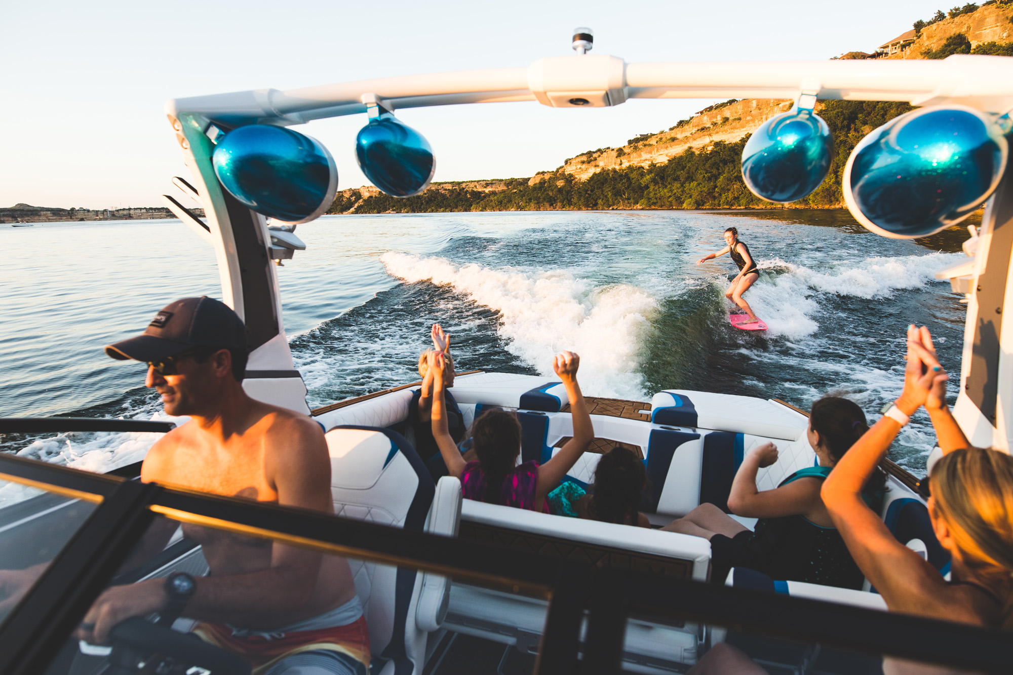 Ski boat with a group of friends towing a wake boarder