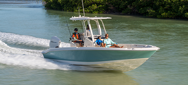 Family cruising on a center console boat through calm coastal waters.