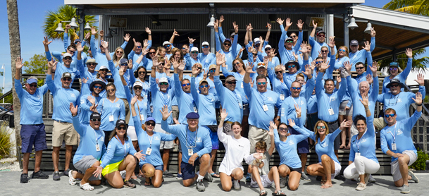 Aquila owners in Aquila shirts smiling at the rendezvous
