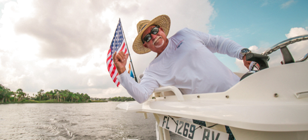 Captain Keith waving a flag on a boat