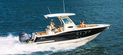 A white and blue Scout boat sails across the water